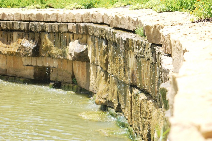Seeping: is the process of water becoming diffused gradually or flowing slowly into or out of materials through small holes, cracks or openings. : Water Vocabulary : Modern/ Dallas/ Pools/ Architectural Fountains/ Water Features/ Baptistry 